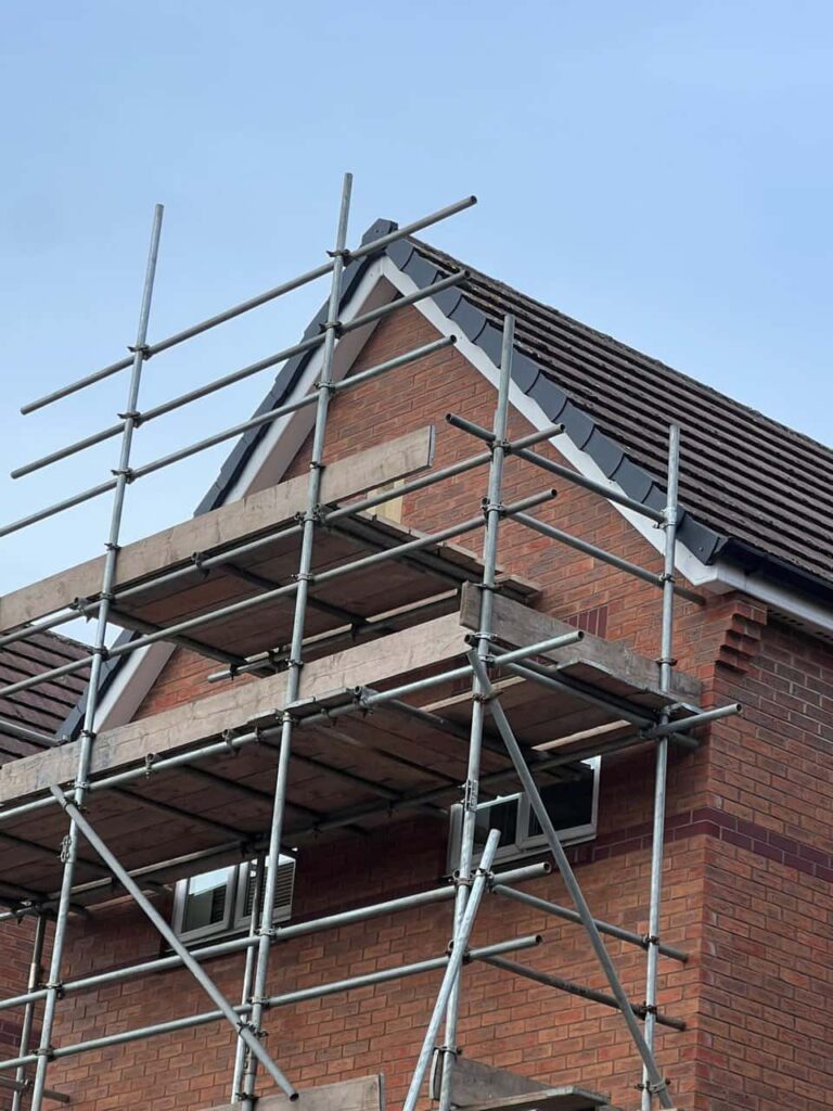 This is a photo of a roof which has just been repaired. There is a scaffold located at the gable end for access onto the roof. Works carried out by Gosport Roofing Repairs